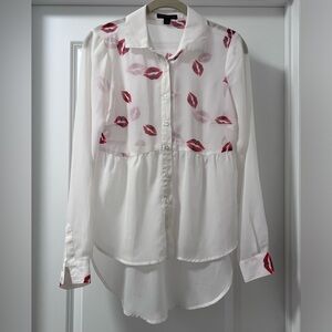 White sheer long sleeve hi low button up with red lips pattern.